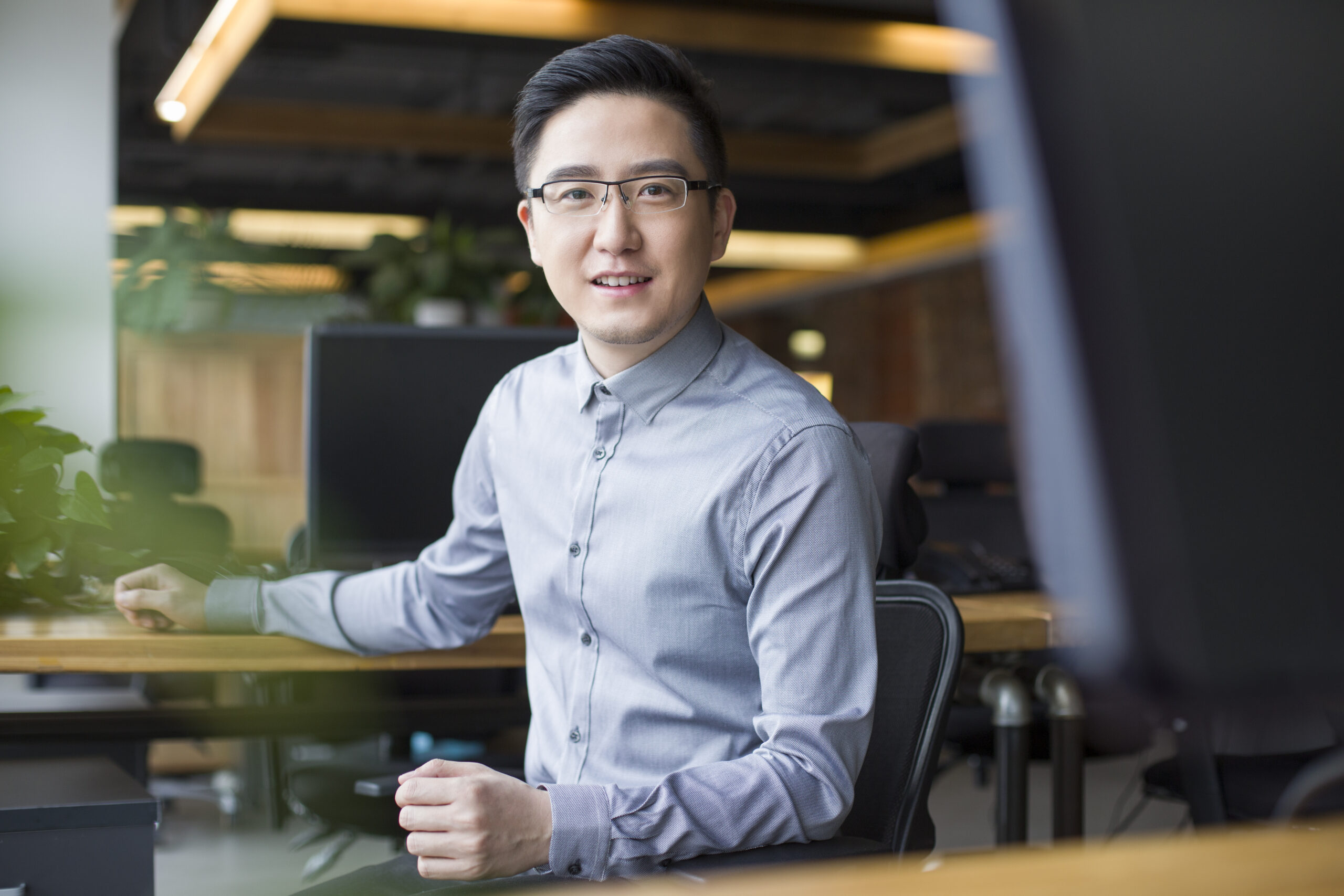 Chinese IT worker sitting in office Chinese IT worker sitting in office
